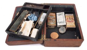 A small collection of various minerals and stones contained within a brown leather writing slope.