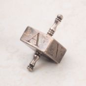 A Georgian silver plated gaming top, with turned shaft and square body inscribed 'H',