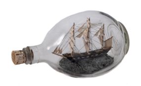 A wooden model of a ship set within a glass bottle.