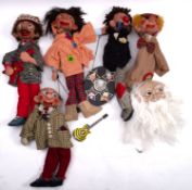 A collection of wooden ventriloquist puppets.