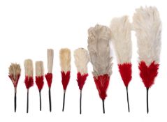 A group of nine late 18th/early 20th century red and white feather plumes, all with baleen sticks,