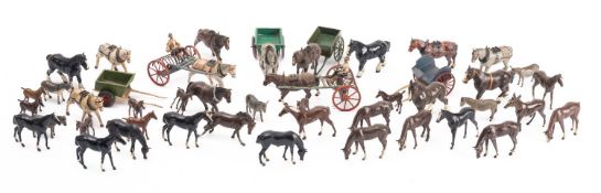 A collection of Britains diecast horses and carts.