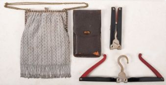 A beadwork cocktail bag and a pair of travelling coat hangers.