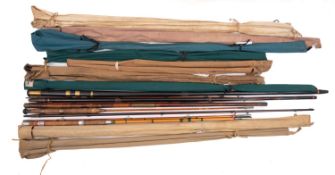 A mixed collection of wooden and split cane fishing rods.