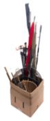 A collection of mainly carbon fibre fishing rods.