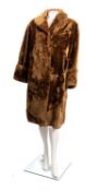 A collection of vintage lady's woollen and fur coats.