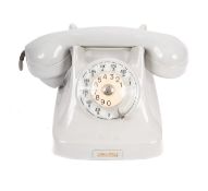 A Vintage rotary dial telephone, in light grey, with coveted lead, 24cm wide.