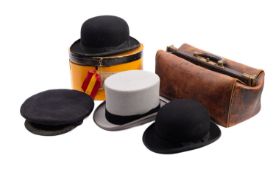 A collection of hats and a Gladstone bag.