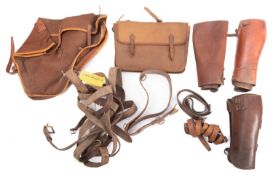 A collection of early 20th century brown leather gaiters and belts,