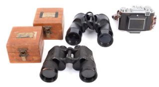 Two pairs of binoculars with attachments.