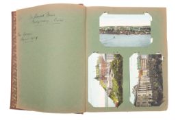 An early 20th century postcard album and contents,