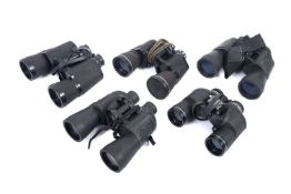 A collection of five modern sets of binoculars.
