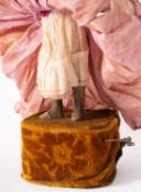 A late 19th century Jumeau automaton doll, the bisque head with applied blonde wig,