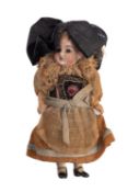 A late 19th Century bisque head doll.