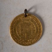 An 1810 George III half guinea (holed).