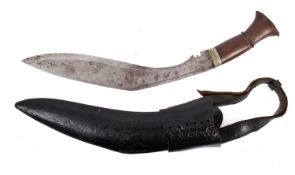A mid 20th century kukri, of traditional form with wooden grip in a black leather scabbard,