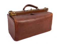 A 20th century leather Gladstone bag. Having a metal frame and leather handle, complete with key.