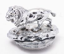 A chrome plated lion passant car mascot, unsigned, raised on a naturalistic base,