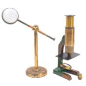 A late 19th/early 20th century lacquered brass microscope condenser, with bullseye lens ,