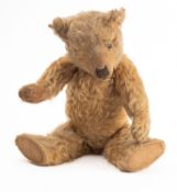 An early 20th Century blond plush Teddy bear.