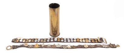 A collection of various Regimental cap badges on a brown leather belt with Victorian brass waist