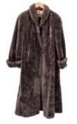 A grey simulated fur full length coat, together with a brown fur cape ,