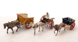 A collection of four Britains diecast horse and cart sets.