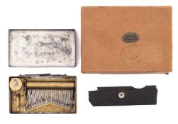 An early 20th century brass miniature music box.