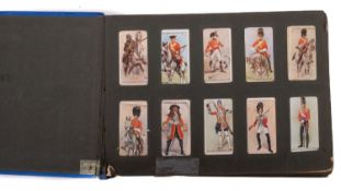 A collection of sets and part sets of cigarette cards in a blue album.