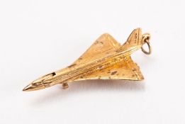 A 9ct gold Concorde pendant, with lowered landing gear and hinged cockpit, 5.9g. 4cm long..