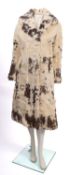 A collection of four fur coats.
