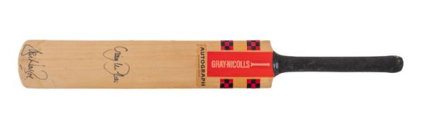A Gray Nicholls autograph cricket bat bearing signatures from Shane Warne and Craig McDermot.