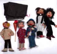 A collection of wooden ventriloquist puppets.