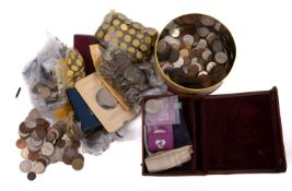 A bag and tin containing a quantity of British and world coins, farthings to crowns.