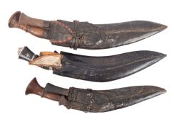 A group of three various kukris in black leather scabbards (3).