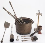 A brass coal bucket and fireside tools.