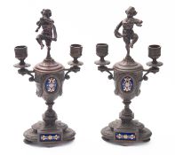 A pair of spelter and enamelled twin lig