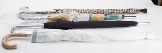 A group of four walking umbrellas, inclu