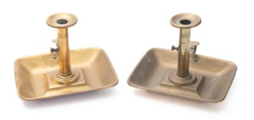 A pair of brass ejector chamber sticks,