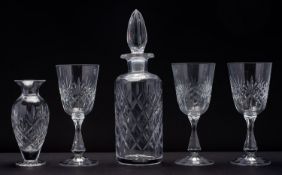 A modern cut glass decanter and wine gla