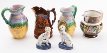 A collection of copper lusterware jugs.