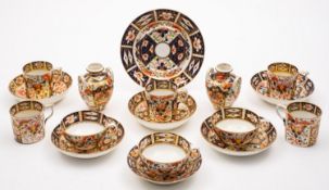 A group of Derby porcelain tea wares, decorated in the Imari pattern comprising three cups,