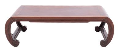 A Chinese huanghuali low table, late 19th Century; the cleated rectangular top on curved legs,