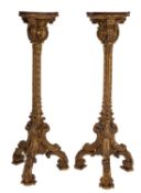 A pair of carved giltwood and composition torchere stands, in Louis XIV style,