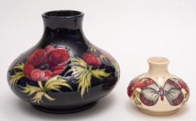 Two John Moorcroft pottery vases, one tube lined in the Poppy pattern,