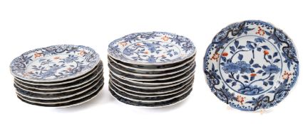 Eighteen Japanese porcelain plates painted in blue and red with some gilt embellishment with