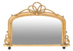 A Victorian giltwood and composition framed overmantel mirror, circa 1875; of shallow arched form,