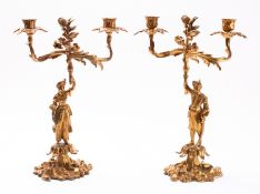 A pair of Continental gilt bronze twin light figural candelabra, in Louis XV style,