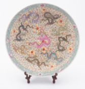 A Chinese famille rose dragon charger enamelled with eight dragons pursuing sacred pearls amongst