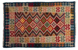 A Turkish Kelim, the stepped lozenge field in red, beige and various colours,